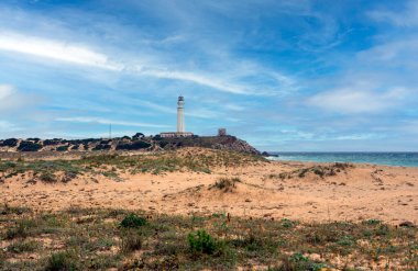 Coast in Conil de la Frontera in the south of Spain with beach in a cloudy day clipart