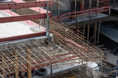 close-up of the remaining rebar at a demolished cement ceiling with sharp broken steel rods