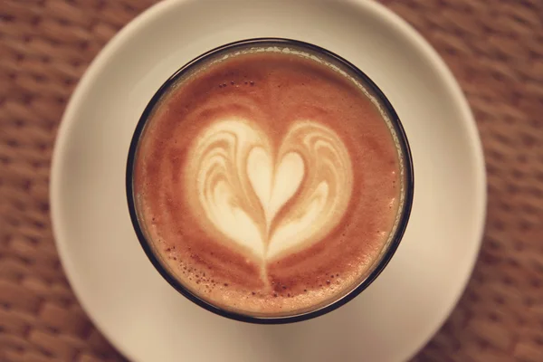 Coffee latte art on Tablecloth texture background - Vintage effe — Stock Photo, Image