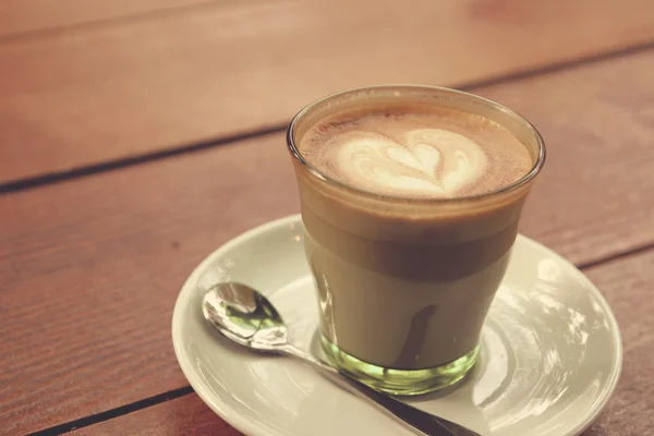 Coffee latte art on the wood texture background - Vintage effect — Stock Photo, Image