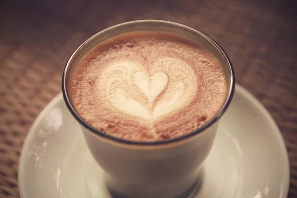 Coffee latte art on Tablecloth texture background - Vintage effe — Stock Photo, Image