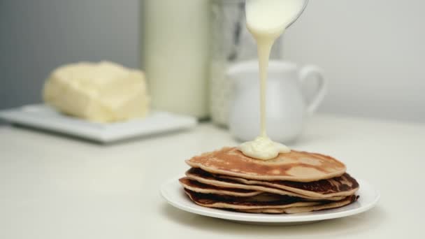 Crema agria o leche condensada vertiendo panqueque en la bolsa. — Vídeo de stock