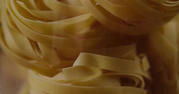 Pasta dry in jar slowly rotate. On a black background. — Stock Video