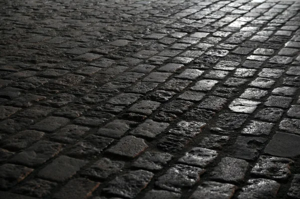 Granite paving stones on the pavement at night. — Stock Photo, Image