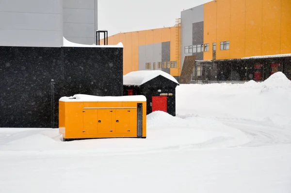 Mobile diesel generator on the territory of an industrial complex for emergency power supply in winter. Electricity.