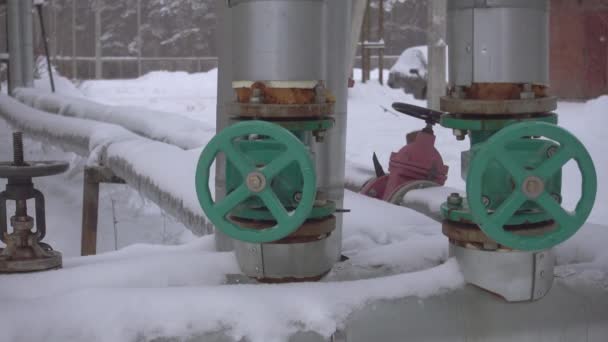 Tuberías y válvulas sobre nieve pesada en invierno. — Vídeo de stock