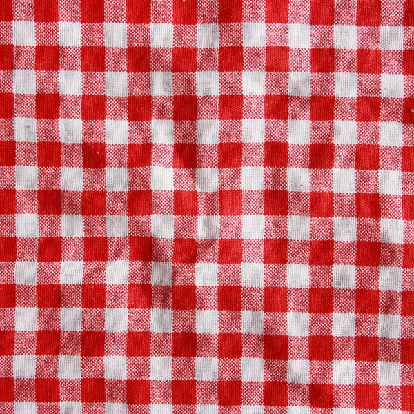 Konsistens av en röd och vit rutig picknick filt. — Stockfoto