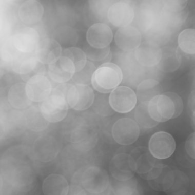 Gri bir arka plan üzerinde ışıklar parıldıyor.