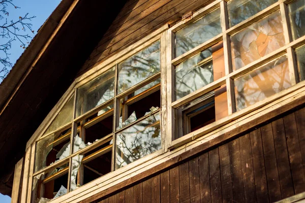 Broken window panes in a country wooden house