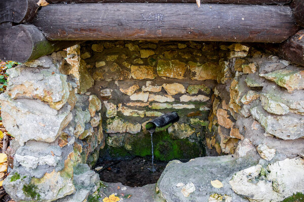 Metal pipe at the place of the source covered with masonry