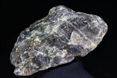 Plagioclase (feldspar) - unworked rock specimen on dark background close up. Russia clipart