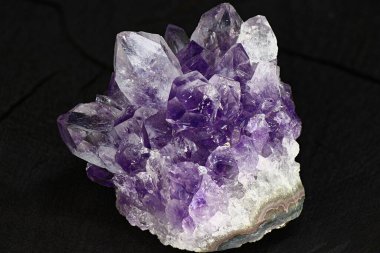 Karanlık bir arka planda parlak, güzel bir ametist druse. Leylak kristalleri kümesi
