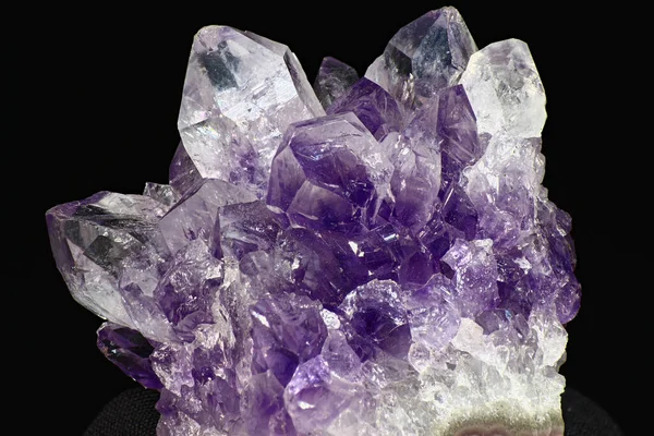 Bright beautiful amethyst druse on a dark background close up. Cluster of lilac crystals