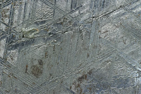 The surface of the Muonionalusta meteorite etched in acid with the Widmanstetten patterns macro