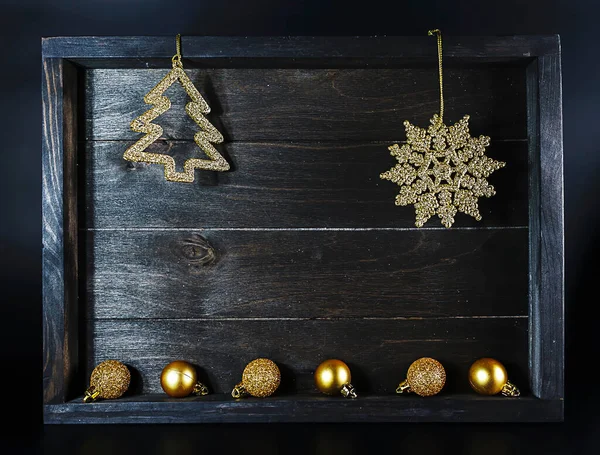 Golden Christmas decoration elements on wooden background — Stock Photo, Image