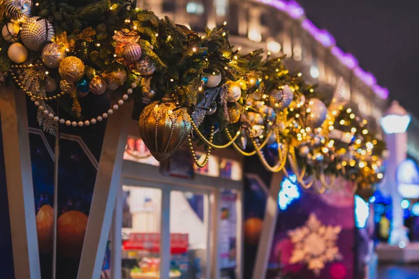Kiosk facade New Year decoration. Closeup Christmas lights and balls at Christmas market