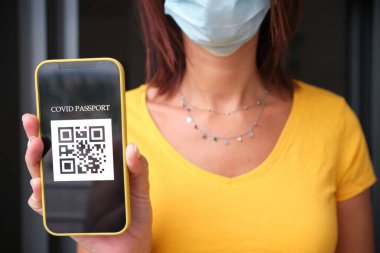 Akıllı telefondan pasaport sahibi tanınmayan bir kadın. Coronavirüs salgını konsepti.