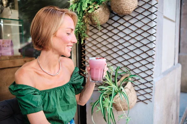 young skinny woman drinking a smoothie