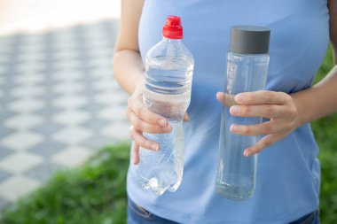 glass bottle instead of plastic water bottle, environmental protection, water splash, green grass