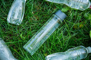 glass bottle instead of plastic water bottle, environmental protection, water splash, green grass