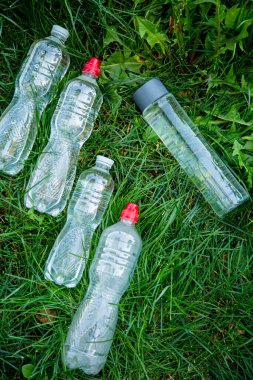 glass bottle instead of plastic water bottle, environmental protection, water splash, green grass