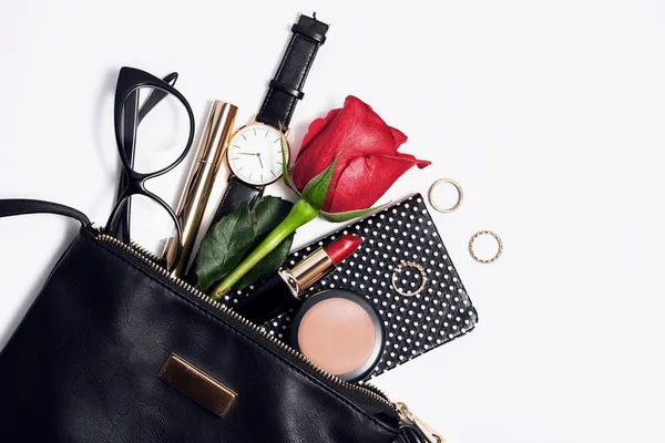 Female fashion accessories in black cosmetic bag. — Stock Photo, Image