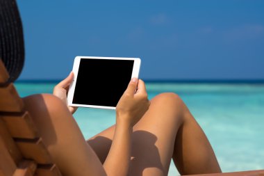 Kadınlar sahilde elinde boş boş tablet bilgisayar