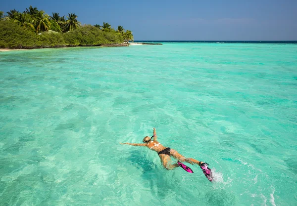 Femme plongée avec tuba dans les eaux tropicales claires en face de l'île exotique — Photo