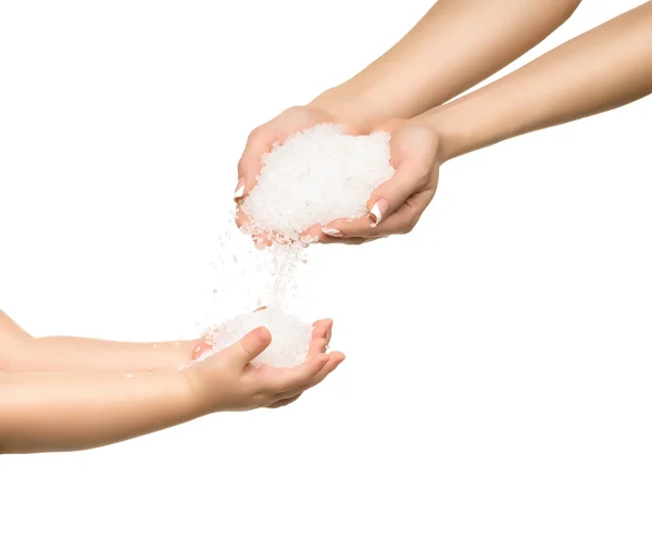Sea salt crystals in women hand and child hand. — Stock Photo, Image