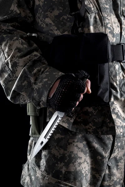 Military man with a knife in a hand close up on the black background — Stock Photo, Image