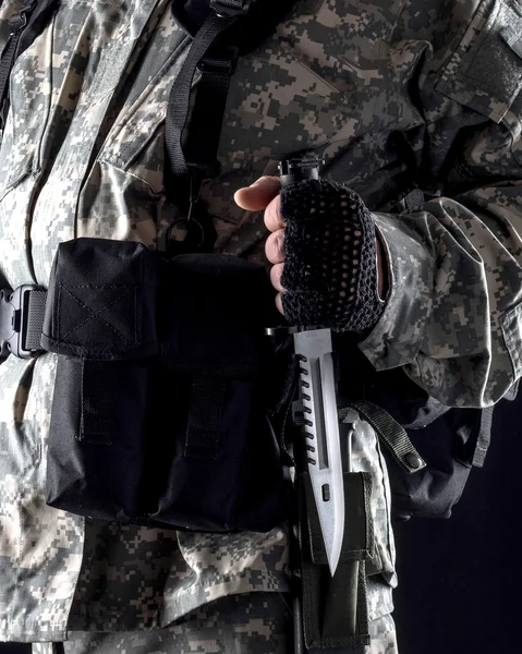 Military man with a knife in a hand close up on the black background — Stock Photo, Image