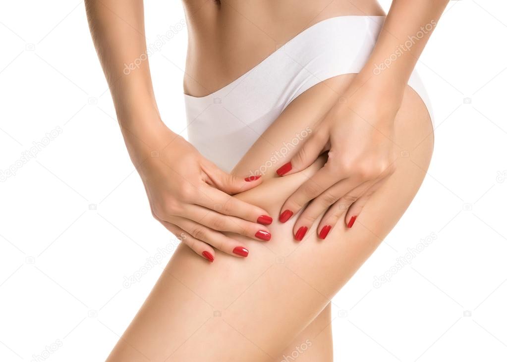 Female squeezing buttock and showing no cellulite