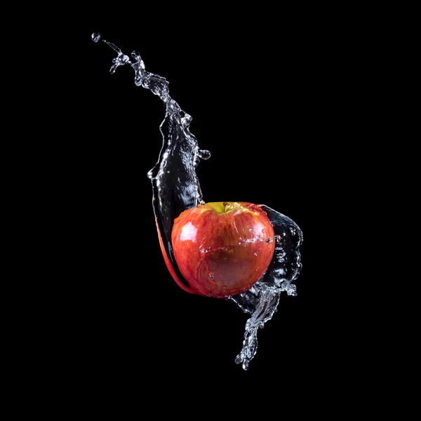 Red apple splashing into water — Stock Photo, Image