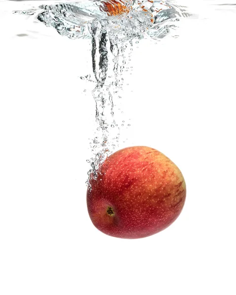 Red apple splashing into water — Stock Photo, Image