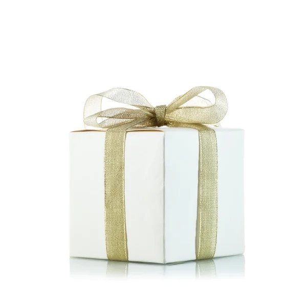 Gift box with golden ribbon bow on white background — Stock Photo, Image