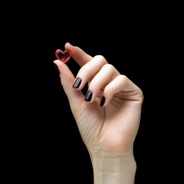 Woman hands holding a small heart as a symbol of love — Stock Photo, Image