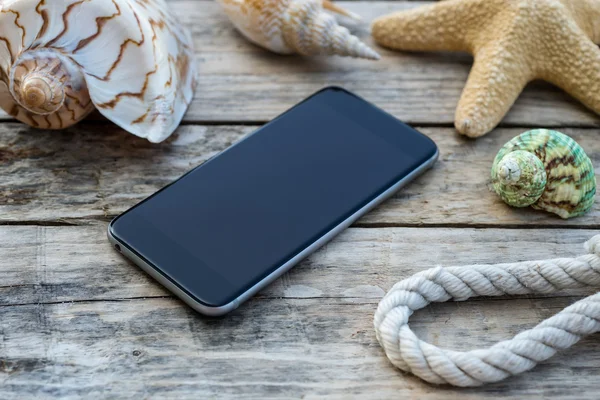 Wooden background with starfish, phone and shell - maritime decoration. — Stock Photo, Image