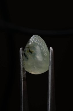 Siyah bir arkaplanda cımbızla doğal bir kavrayış taşı