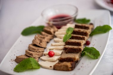 Beyaz bir tabakta ovalar kesiliyor.