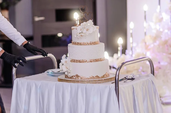 Beautiful wedding cake decorated with flowers, cake close up and blur background