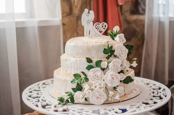 Beautiful wedding cake decorated with flowers, cake close up and blur background