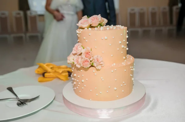 Beautiful wedding cake decorated with flowers, cake close up and blur background