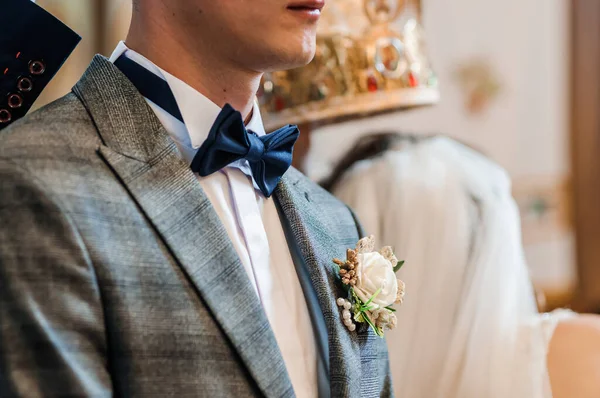 Blue bow tie around the neck of a man