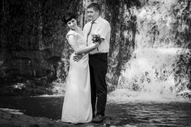 Şelalenin arka planında yeni evliler