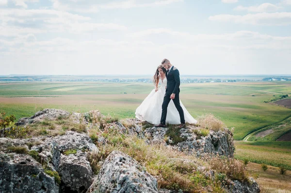 Frischvermählte Umarmen Sich Auf Dem Hintergrund Von Felsen — Stockfoto