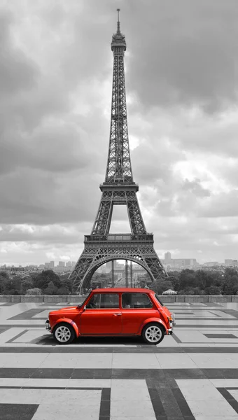 Eiffel tower with car. Black and white photo with red element. — Stock Photo, Image