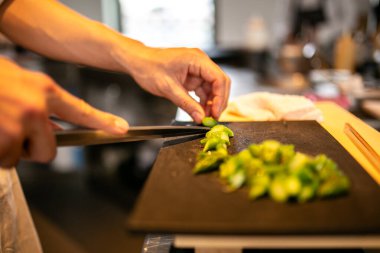 Restoran Mutfağında Yeşil Sebzeleri Kesme Kurulu 'nda dilimleyen Şef. Yüksek kalite fotoğraf