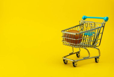 Küçük alışveriş arabasında kahverengi tavuk yumurtası, içinde bir yumurta olan mini market arabası.