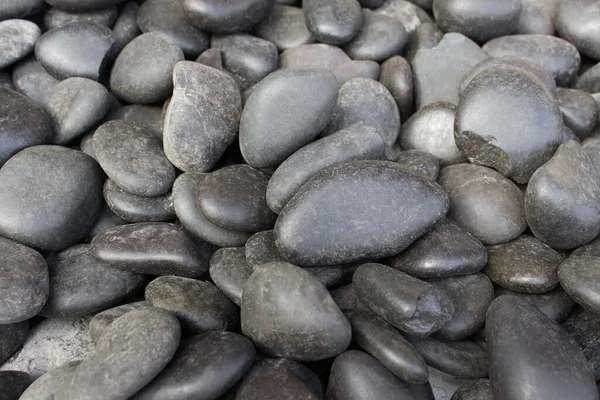 Много Круглых Блестящих Черных Камней Гальки — стоковое фото