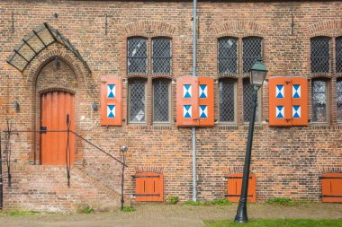 Front facadewith shutters of the Broerenklooster monastery in Zwolle, Netherlands clipart